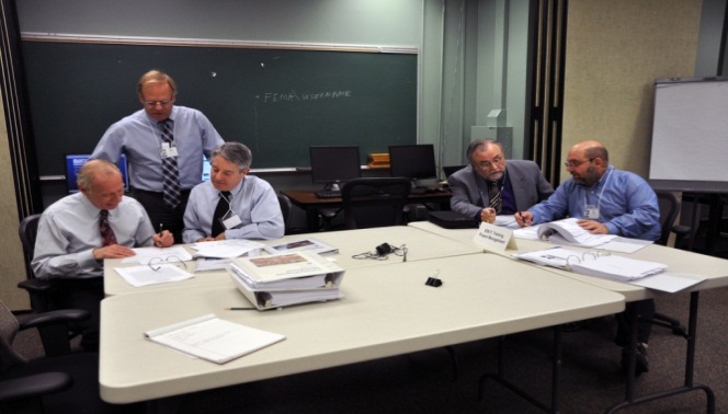 Emmitsburg, Md., February 20, 2014 -- The National Coordinator and Reviewers from the American Council on Education examine EMI course materials during the February 20-21, 2014, site visit.